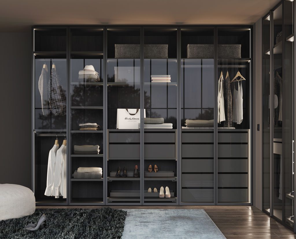 Detail of the walk-in wardrobe with glass doors with interior LED light Detail of the walk-in wardrobe with glass doors with interior LED light